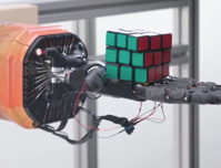 A robot hand taught itself to solve a Rubik s Cube after creating its own training regime MIT Technology Review