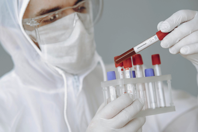 Crop scientist holding test tube with positive coronavirus result Free Stock Photo
