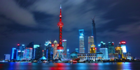 Night Skyline with bright lights in Shanghai, China . Image via GoodFreePhotos