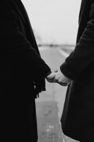 Grayscale Photo of Couple in Black Coat Holding Hands Free Stock Photo