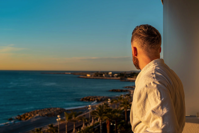 Man Wearing Bathrobe While Looking Out in the Scenery Free Stock Photo