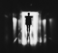 Monochrome Photo of Person Standing on Hallway Free Stock Photo