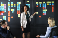person leading a meeting with postits