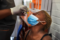 Volunteer Thabisle Khlatshwayo is tested for the coronavirus before receiving a AstraZeneca's covid-19 vaccine in November at Soweto's Chris Sani Baragwanath Hospital outside Johannesburg,
AP PHOTO/JEROME DELAY