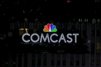 FILE PHOTO: The NBC and Comcast logo are displayed on top of 30 Rockefeller Plaza, formerly known as the GE building, in midtown Manhattan in New York