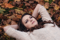 Beautiful Girl In The Park Lying On The Leaves