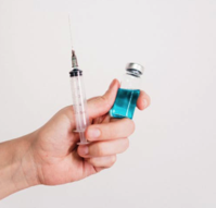 Person Holding Syringe and Vaccine Bottle Free Stock Photo