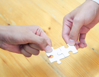 Person Holding White Jigsaw Puzzle Piece Free Stock Photo