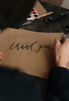 Person Writing on Brown Printer Paper Free Stock Photo