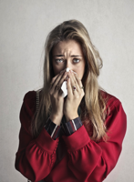 Photo of Crying Woman in Red Long Sleeve Shirt Blowing Her Nose Free Stock Photo