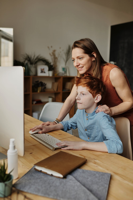 Photo of Woman and Boy Looking at Imac Free Stock Photo