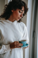 Woman concerned drinking cup of coffee