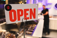Shallow Focus Photography of Red and White Open Signage Near Man Wearing Black Shirt Free Stock Photo
