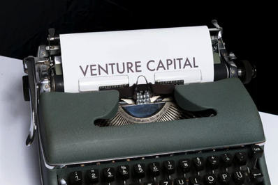 Typewriter with Venture Capital on a piece of paper coming out.