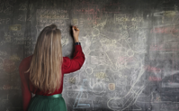 Woman in Red Long Sleeve Writing On Chalk Board Free Stock Photo