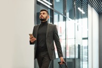 Young businessman in formalwear pulling suitcase w 2021 09 24 03 13 17 utc